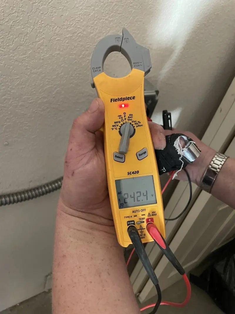 Voltage testing with clamp meter during Ceiling Fan Installation in Bowie